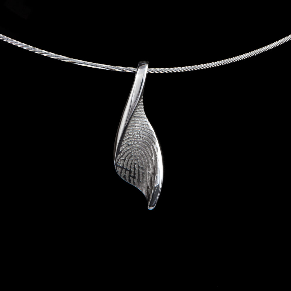 Handgemaakte zilveren vingerafdruk hanger met duidelijke lijnen, symbool voor de betekenis van een vingerafdruk sieraad en persoonlijke herinnering
